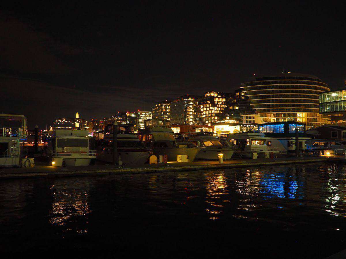 The Wharf marina and waterfront buildings lit up at night